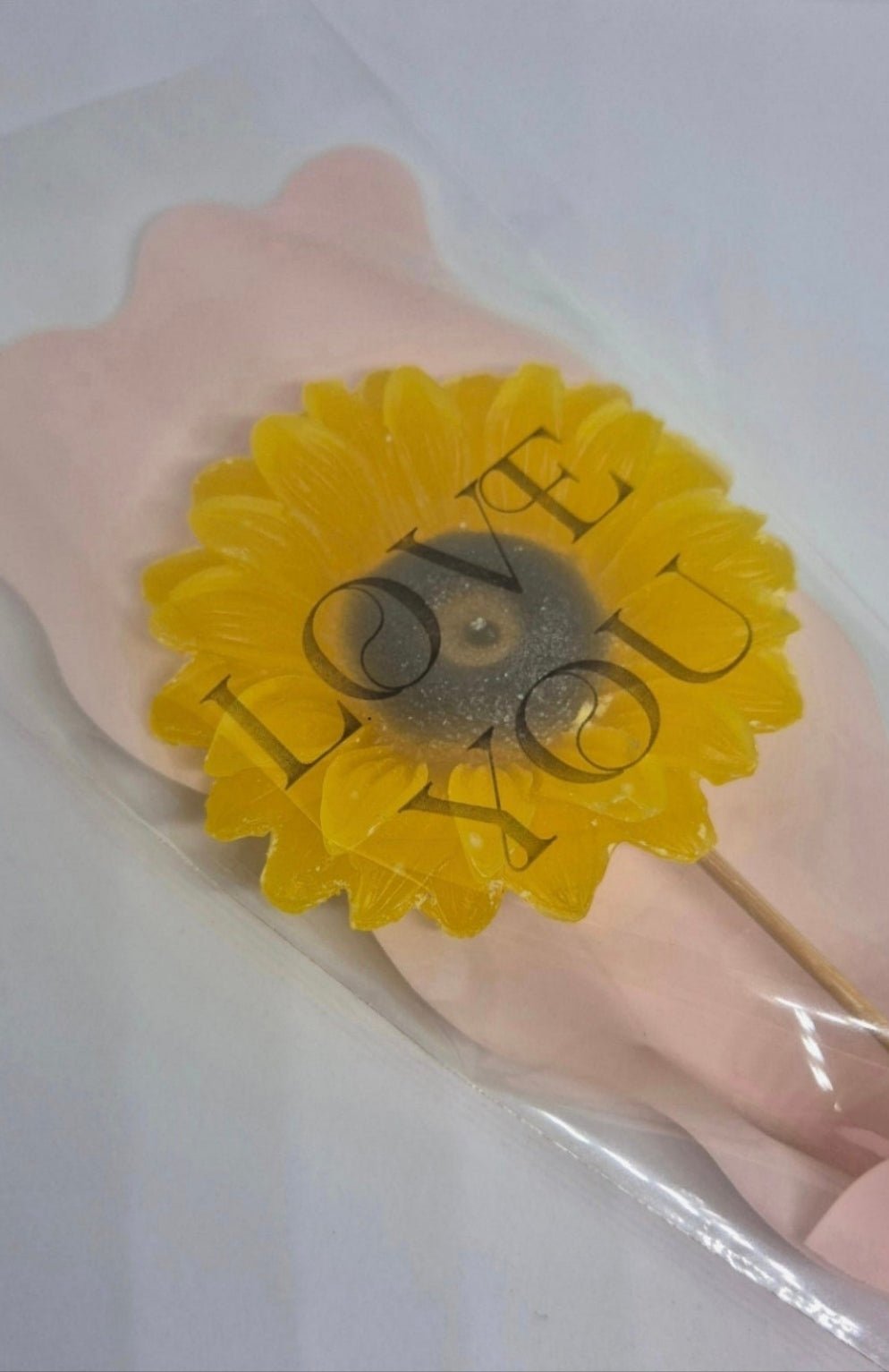 single sunflower wax melt in pink packaging 